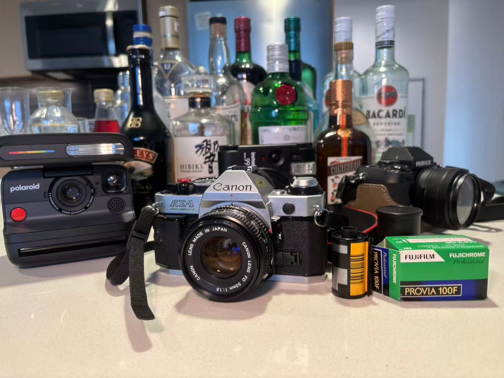 Cameras and film arranged in front of a home bar
